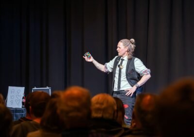 Henry Oz showing a solved Rubiks cube to the audience during a close up moment at a magic show in the San Juan Islands